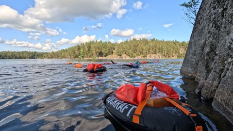 Swimmers are swimming in the lake