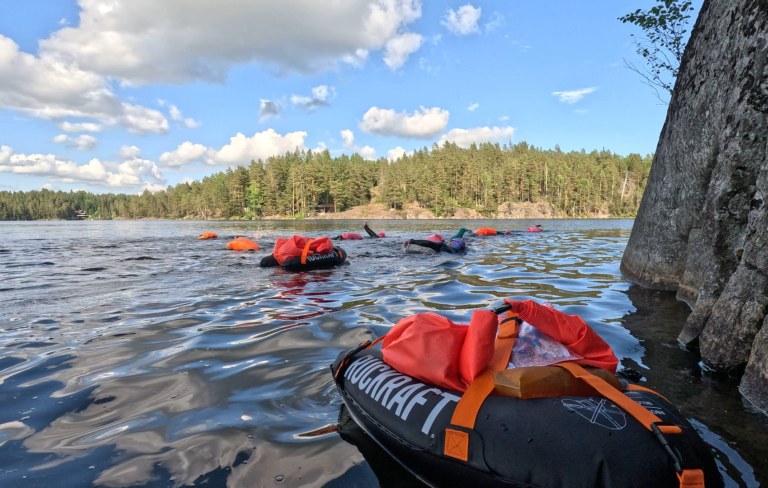 Swimmers are swimming in the lake