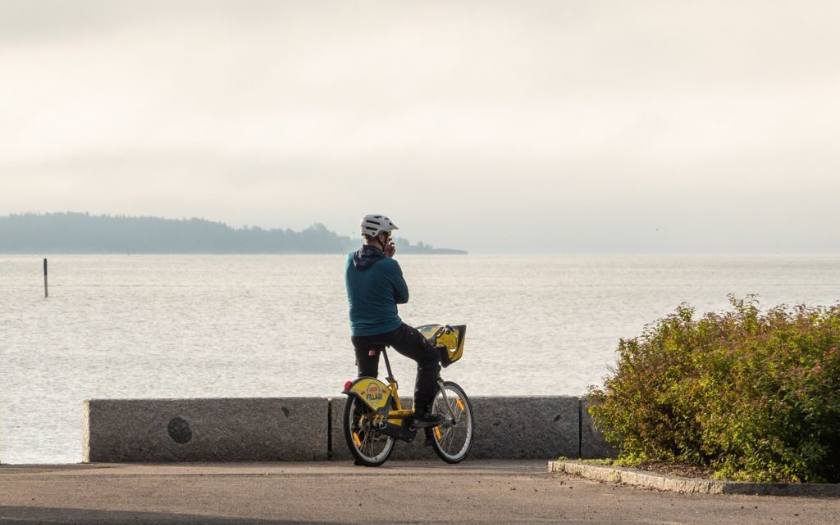 Man on city bike admiring sea