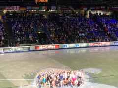 Group of Figure skaters posing on ice for photo in Espoo Metro Arena
